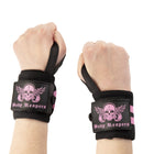 Athlete wearing the pink accented Body Reapers wrist wraps on both wrists during a lift